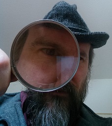 The author looking through a magnifying glass